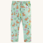 Frugi Little Libby Printed Leggings - Riverine Rabbits, made from GOTS Organic Cotton. A beautiful spring-time print of yellow, white and pink flowers, bees, ladybirds and brown bunnies, and on a light mint green fabric. The leggings are shown on a cream 