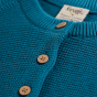 Button and material detail on the Frugi Colby Cardigan - Fairy.