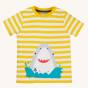 Frugi Children's Organic Cotton Sid Applique T-Shirt - Shark. The front of the short-sleeved t-shirt showing a fun Shark applique design splashing in the sea on a sunny yellow and white striped fabric. T-shirt is on a cream background