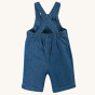 The back of the Frugi Organic Carnkie Chambray Denim Dungarees - Tractor, showing the straps and elasticated waistband, on a cream background