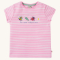 Frugi Children's Organic Cotton Camille Applique T-Shirt - Bee Great. A light pink and white stripe short sleeve t-shirt with an embroidered bee, leaf, lady bird and flower, with the text "Bee great and pollinate" underneath. On a cream background