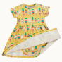Frugi Dara Baby Body Dress with a yellow Rainbow Sprinkles design with the bodysuit closure seen underneath pictured on a plain background