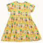 Back of the Frugi Dara Baby Body Dress with a yellow Rainbow Sprinkles design pictured on a plain background