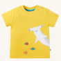 Frugi Children's Organic Cotton Jaime Applique T-Shirt - Shark. The front of the short-sleeved t-shirt showing shoulder pop fasteners, a fun Hammerhead Shark applique design and colourful fish on a sunny yellow fabric. T-shirt is on a cream background