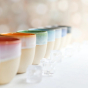 Glosters Pottery Drinks Tumbler. All the ceramic tumblers are lined up in a row creating a rainbow effect