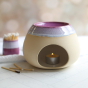 Glosters Ceramic Wax Melt Burner in Heather Purple is beautifully showcased in a home setting, on a white herringbone patterned table. With a Heather Purple coloured indent glaze surrounded by a foamy white glaze mimicking sea waves crashing against the s