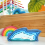 Gluckskafer Stacking Dolphin wooden toy puzzle. Other wooden toys can be seen in the background.