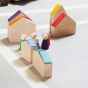 Grapat Nins® and Houses Set including 6 colourful Nin peg people and 6 coordinating colour abstract houses. Houses set up as a village with the Nins having a meeting in the centre. Great for colour matching and imaginary play. White background.