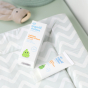 calming nappy cream from the Organic Babies Newborn Collection Gift Set pictured on  a changing mat