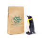 Green Rubber Toys eco-friendly biodegradable penguin toy on a white background next to its recyclable paper bag packaging
