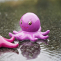 purple octopus from the Green Rubber Toys Sea Friends Bath Toy Set pictured in a puddle of water