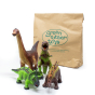 Green Rubber Toys eco-friendly natural rubber dinosaur set on a white background next to the recyclable paper bag packaging