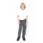 A child wearing Eco Outfitters GOTS organic cotton school uniform trousers - boys slim fit in grey, with a white polo shirt and black shoes, smiling with right thumb in pocket. White background
