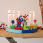 Grimm's 12-Hole Blue-Green Wooden Celebration Ring with 6 white candles and decorative figures to celebrate a 6th birthday