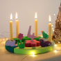 Grimm's Green-Turquoise Celebration Ring with lit beeswax candles and decorative figures to celebrate a 4th birthday