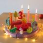 Grimm's 12-Hole Pink-Purple Wooden Celebration Ring with pink candles, wire fairy lights and decorative figures to celebrate a 3rd birthday