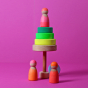 Grimm's Small Conical Stacking Tower - Neon Green - On a plain pink background. Alternative puzzle layout with Grimm's Neon Friends alongside.