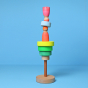 Grimm's Small Conical Stacking Tower - Neon Green - On a plain blue background. Alternative puzzle layout with Grimm's Neon Friends included in the construction.
