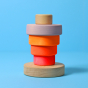 Grimm's Small Conical Stacking Tower - Neon Pink - On a plain blue background. Alternative puzzle layout.