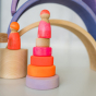 Grimm's Small Conical Stacking Tower - Neon Pink - On a plain cream background. Grimm's Neon Pink Friends are on top of the Tower.