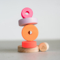 Grimm's Small Conical Stacking Tower - Neon Pink - On a plain cream background. Alternative puzzle layout.