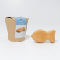 Grimm's Wooden Baby Rattle - Fish in a natural alder wood finish next to its cardboard packaging box, plain background
