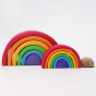 Grimm's Wooden Medium Rainbow next to the Mini Rainbow and snail shell for scale on a grey background