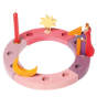 Grimm's 12-Hole Pink-Purple Wooden Celebration Ring with a candle and decorative figures on a white background