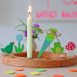 Grimm's Sweet Cone Decorative Figure - Neon Green. The cone sits inside the Celebration ring alongside other figures and a candle.