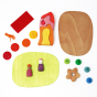 Pieces of the Grimm's plastic-free wooden small world play toy set laid out on a white background