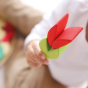 Close up of a child holding the plastic-free Grimm's Lara building blocks in a flower shape