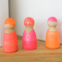 Grimm's Friends - Neon Pink - The peg dolls sit on a shelf in a home environment.