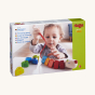 HABA Number Dragon Threading Game box showing a child playing with the blocks and the thread, on a cream background