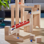 HABA Large Marble Run Tracks, block set. A fun and interactive set of marble run blocks that can be built if different ways, showing the natural wooden blocks, a metal bell that the balls hit on the way down and a ladder with zigzag steps for the marbles 