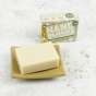 Hand Blocks Essential Oil Hand Soap Bar and Box - Lemon & Rosemary with the soap on a ceramic soap dish on a white speckled background