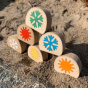 Stack of Hellion Toys eco-friendly temperature blobs on a sandy beach