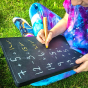 Close up of child doing maths equations on a Hellion Toys natural wooden laptop chalking board