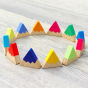 ring of Hellion Toys eco-friendly handmade wooden rainbow mountains on a grey wooden floor