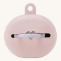 Hevea pink natural rubber baby dummy case with a dummy inside on a beige background