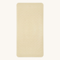 Hevea natural rubber bath mat in the sand colour on a beige background