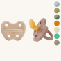 Hevea natural rubber orthodontic pacifier on a beige background