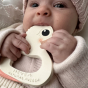 Baby grasping the Hevea Natural Rubber Teether - Kawan the Duck 