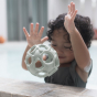 Child bouncing a Hevea Natural Rubber Upcycled Star Activity Ball