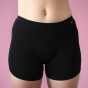 Hey Girls My Period Shorts from the front, in Black on a pink background