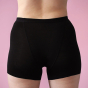 Hey Girls My Period Shorts from the back, in Black on a pink background