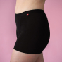 Hey Girls My Period Shorts from the side, in Black on a pink background