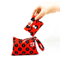 Hey Girls Reusable Red Period Wet Bag with a folded pad held in someone's hand on a white background