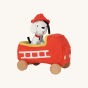 Front view of Olli Ella Holdie Dog-go Chief in a red felt fire truck with wooden wheels, wearing a red fire fighter helmet on a cream background