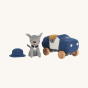Olli Ella Holdie Dog-go Officer next to a blue felt police car with wooden wheels, a blue police officer helmet and wearing a silver star collar