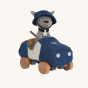 Side view of Olli Ella Holdie Dog-go Officer in a blue felt police car with wooden wheels, wearing a blue police officer helmet and silver star collar